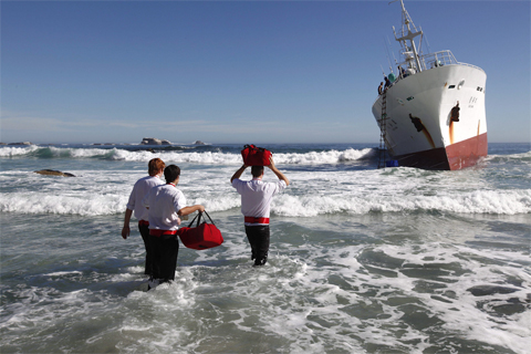 Three[-]pizza[-]delivery[-]workers[-]carried[-]hot[-]pizza[-]to[-]members[-]of[-]the[-]crew[-]of[-]the[-]Japanese[-]fishing[-]trawler[-]Eihatsu[-]Maru[-]after[-]it[-]ran[-]aground[-]off[-]the[-]exclusive[-]Clifton[-]beach[-]in[-]Cape[-]Town,[-]South[-]Africa,[-]May[-]15.[-]Nic[-]Bothma/European[-]Pressphoto[-]Agency
