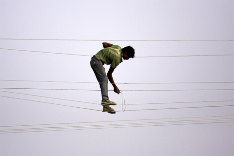 A[-]utility[-]worker[-]made[-]adjustments[-]to[-]power[-]lines[-]in[-]Allahabad,[-]India,[-]Nov.[-]18.[-]Sanjay[-]Kanojia/Agence[-]France-Presse/Getty[-]Images